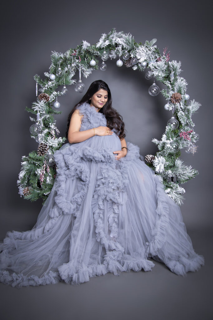 a pregnant women wearing light violet gown standing with her sister