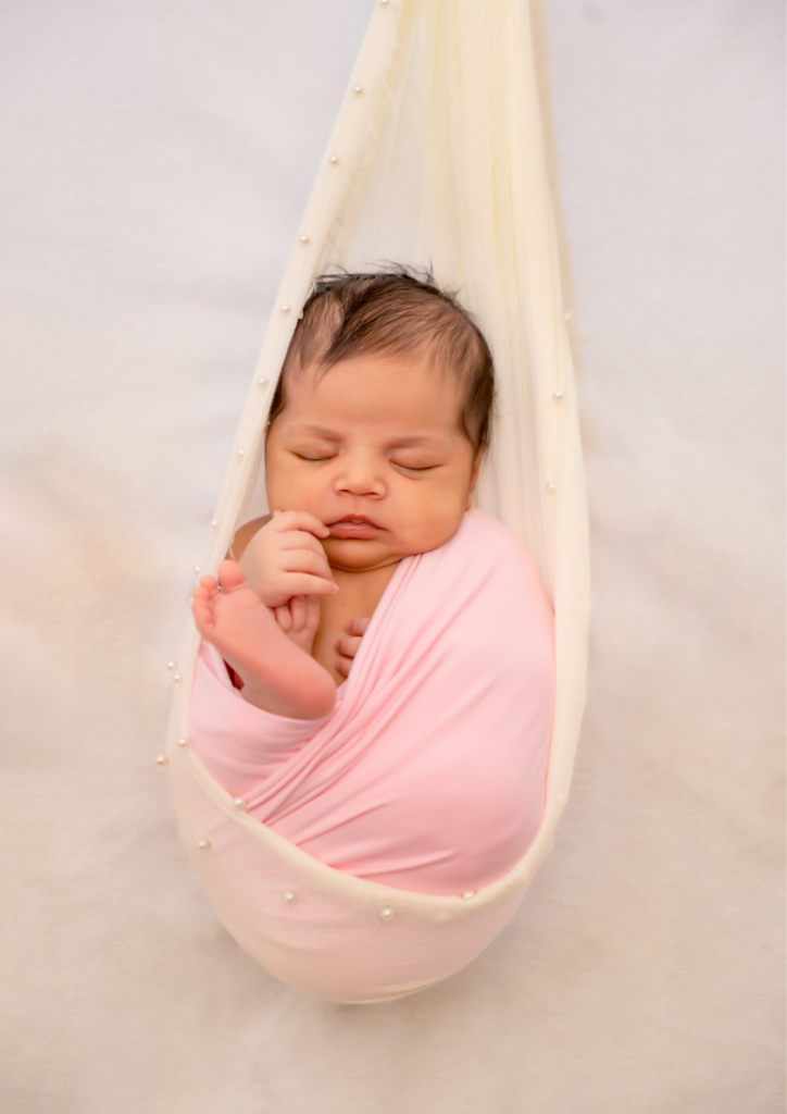 newborn baby wearing baby pink clothes