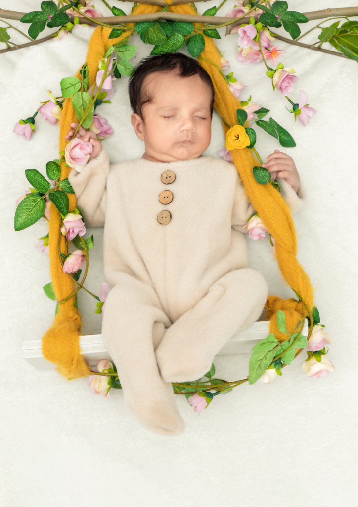 newborn baby wearing baby pink clothes sleeping