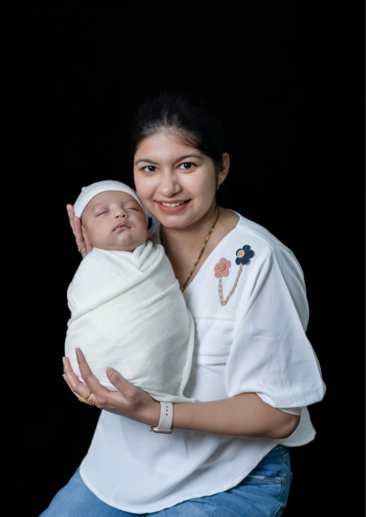 a women holding her baby in her hands looking happy